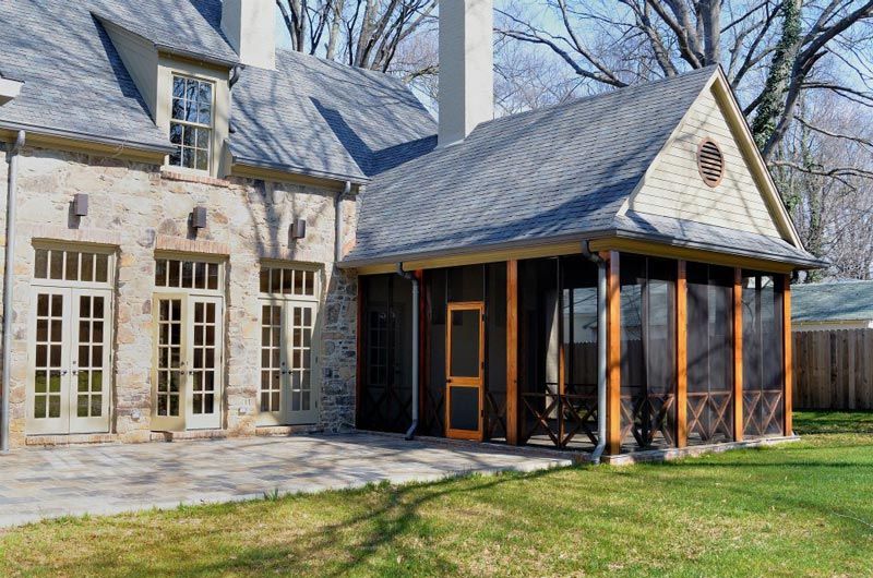 photo of custom cedar screen porch addition to home